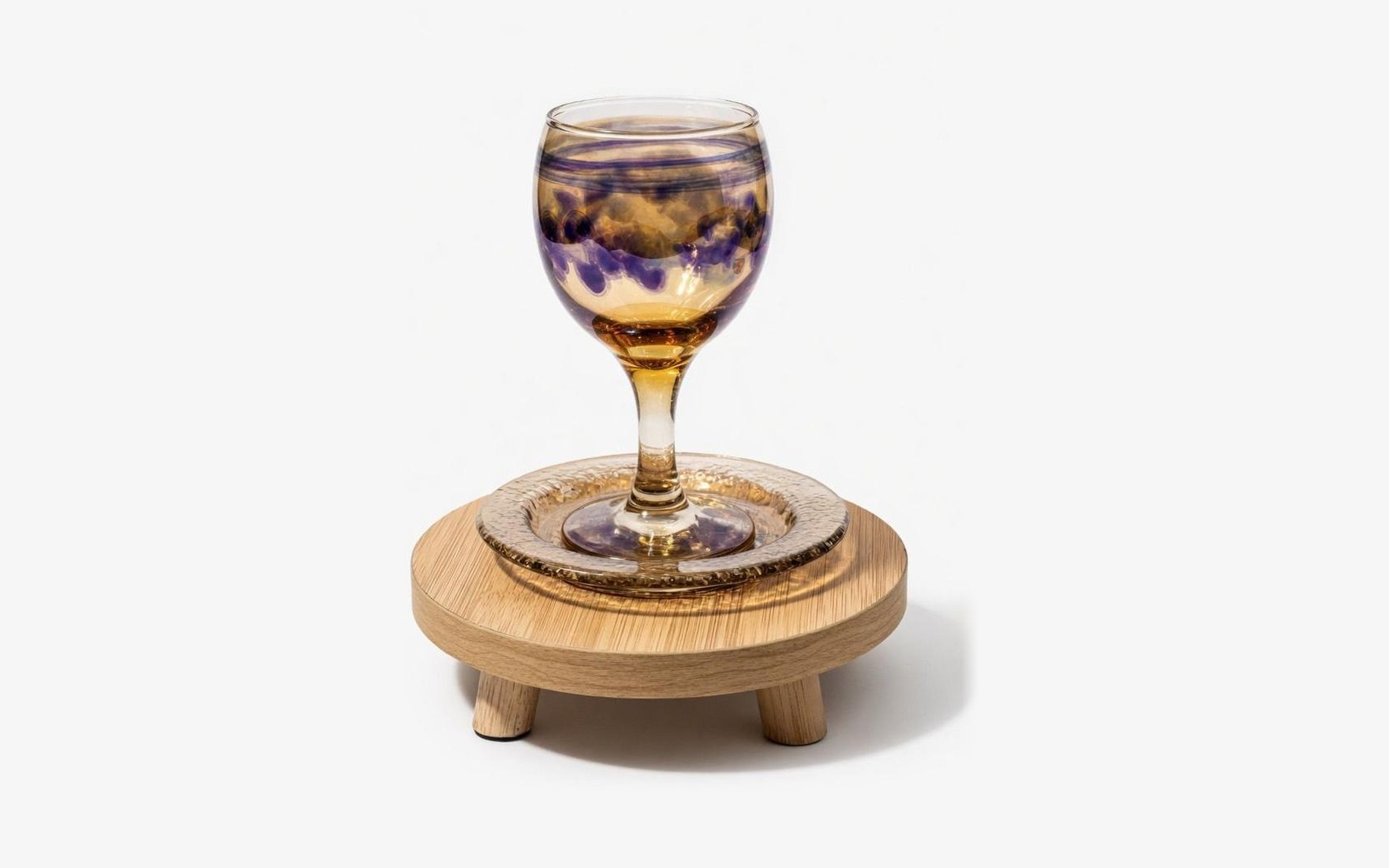 A hand-blown goblet with purple and amber swirls