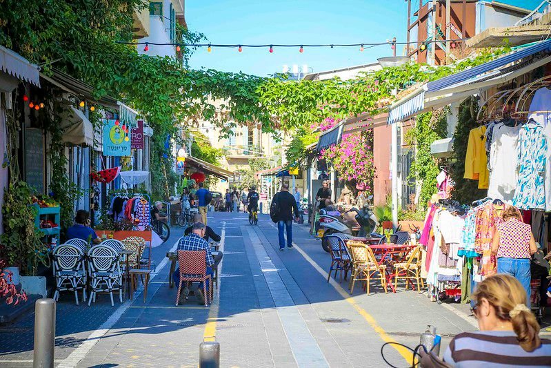A shaded lane in the Jaffa flea market with cafes and shop stalls